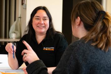 foodbank volunteer talks with another woman
