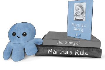 Blue octopus teddy next to a pile of books that say "the story of martha's rule"