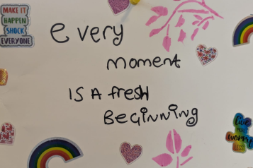 writing on a wall "every moment is a fresh beginning"