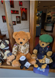 Teddy bears dressed in different armed forces uniforms.