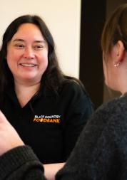 foodbank volunteer talks with another woman