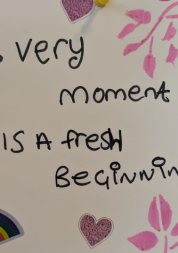 writing on a wall "every moment is a fresh beginning"